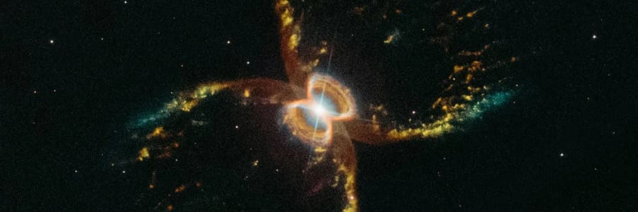 Colorful nebula resembling a cross-shaped stellar explosion surrounded by glowing gas and dust.
